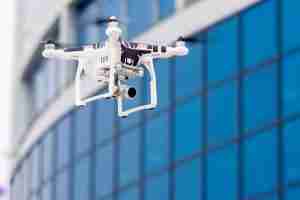 drone flying by building
