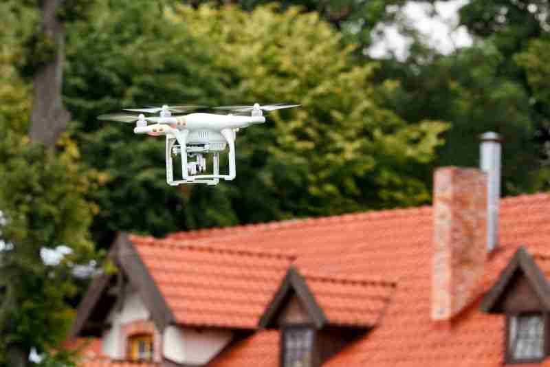 drone flying in front of house