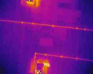 The white arrow indicates areas of moisture underneath the surface membrane.