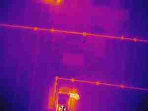 The white arrow indicates areas of moisture underneath the surface membrane.